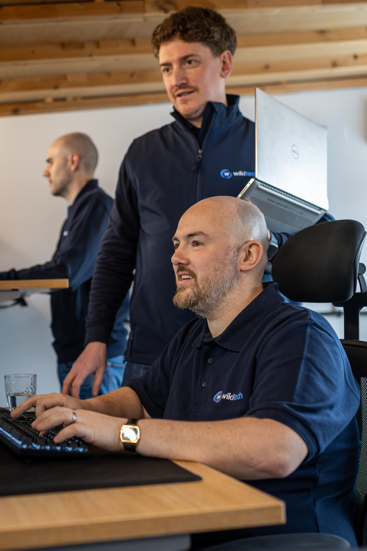 WikiTech engineer providing support at their desk